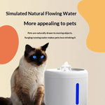 Cat sitting next to a pet water fountain with text about simulated natural flowing water.