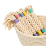 Beige rope with colorful tags in a woven basket on a white background