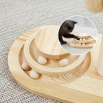 Cat batting the ball toy set into the wooden base