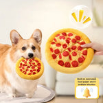 Dog playing with a pizza-shaped toy held by a person