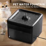 Pet water fountain with a cat sitting next to it on a wooden floor.