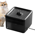 Pet water fountain with a cat sitting next to it on a wooden floor
