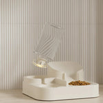Modern pet feeder with a transparent water dish on a neutral background